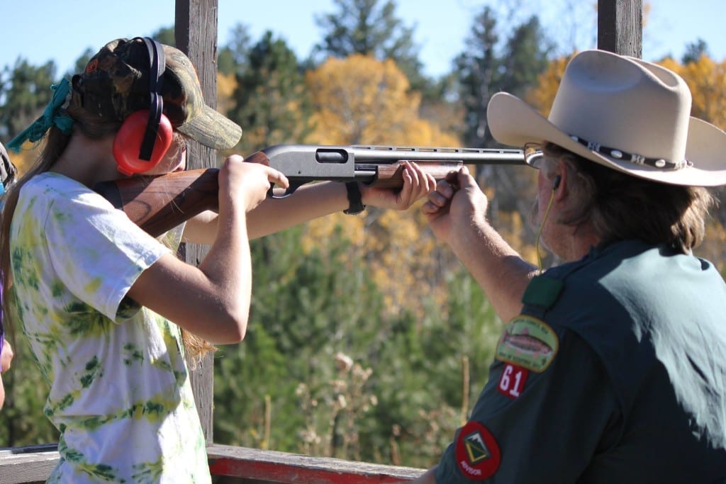 Photo Contest winner, Adult Honorable mention: Patti Scanlan, K-M Venture Camp. Female Venturer is mentored in the safety measures involved before shooting.