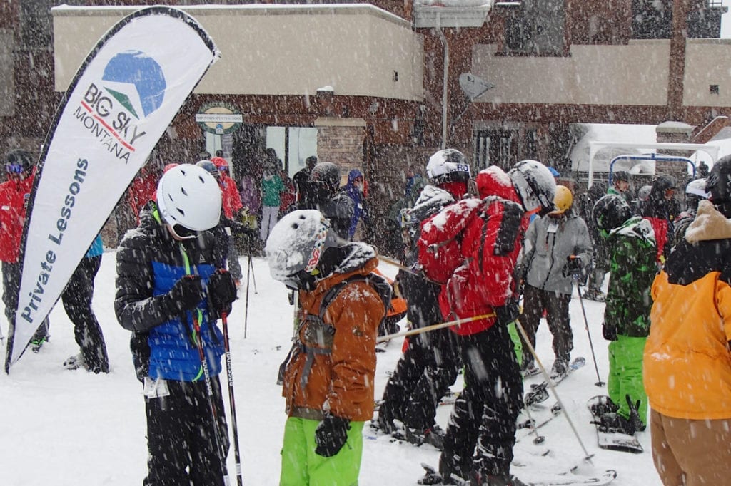 Several boys in ski gear (including helmets, goggles) wait to begin private ski lessons at Big Sky Resort outside Bozeman, Montana.