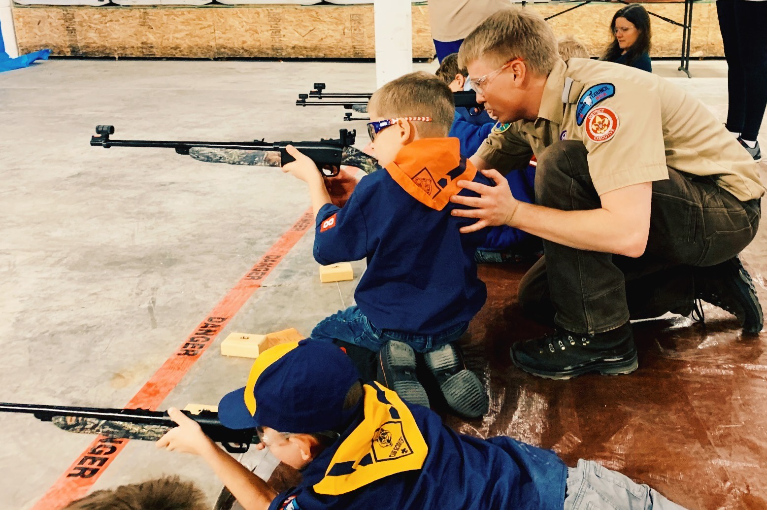 Photo Contest, Adult honorable mention 2: Mountain Valley District - Montana Council Boy Scouts of America District Executive Daniel King guiding a young Cub. Amanda Dreadin, Pack 3648, Belgrade.