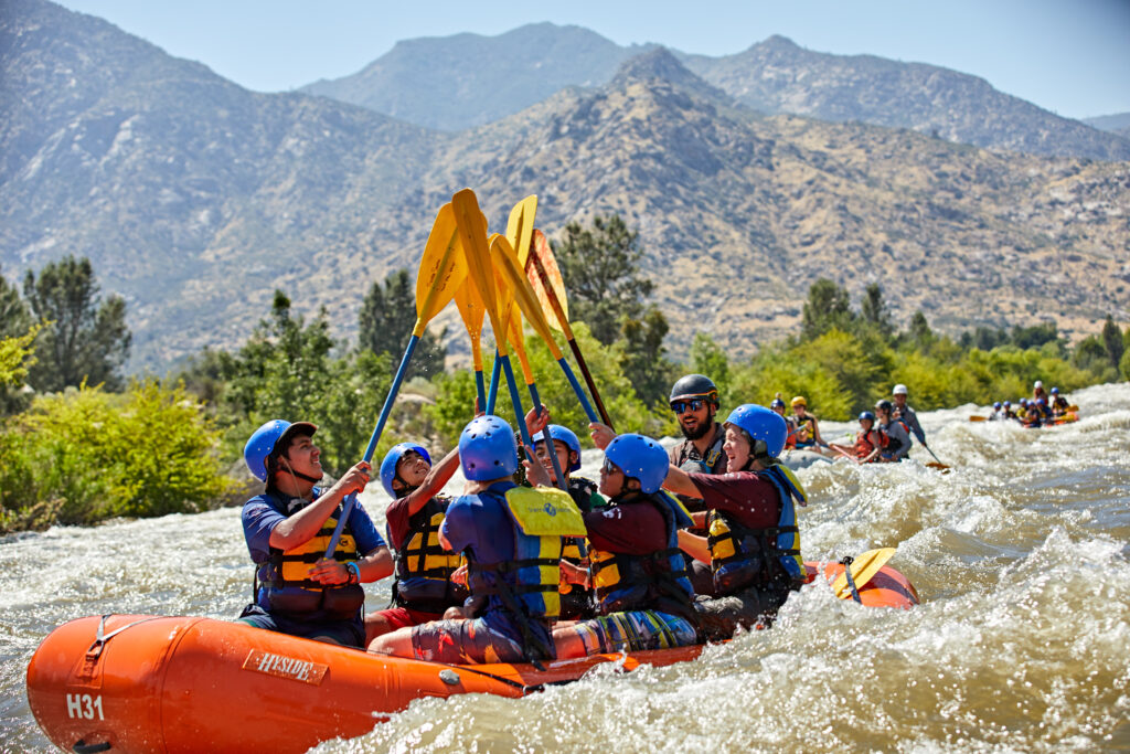 Scouts on an outdoor adventure, whitewater rafting together through the mountains. 