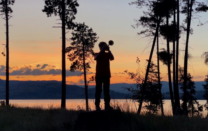 Contest Category: Youth (17 and under)
Photographer's Name: Cal Thompson
Parent or Guardian Name : Steve Thompson
Email: kcolln@yahoo.com
City & Unit Number: Missoula, 1911

Image Description: Troop 1911 Bugler, Knox Henderson, playing "Tattoo" at summer camp on Melita Island which is the precursor to Taps/lights out.
Image Upload: https://scoutingmontana.org/wp-content/uploads/elementor/forms/6949ea1420347.jpeg
