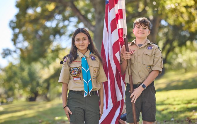 Holding an American flag - Scouts BSA 2025 American Flags